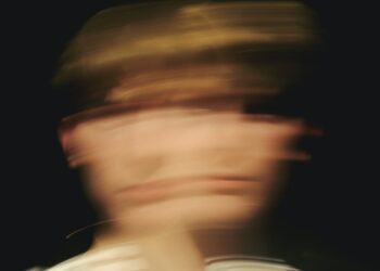 man in white shirt wearing black cap