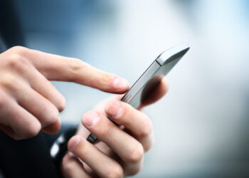 Close up of a man using mobile smart phone