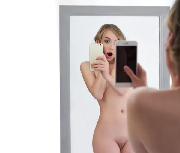 Sexy naked woman taking a selfie with her smart phone